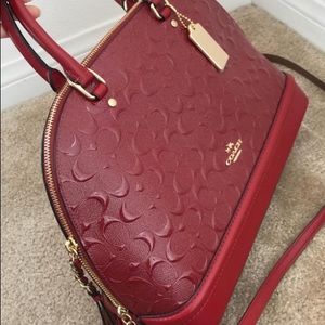 Red de bossed Satchel coach